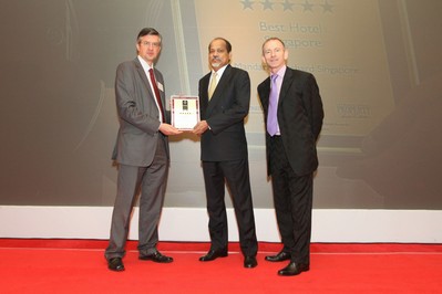 Michael Sengol (centre), Meritus Hotels & Resorts CEO, receiving the Best Hotel Award for Mandarin Orchard Singapore from Stuart Shield (right), President of the International Hotel Awards, and Bill Jones (left), from Royal Institution of Chartered Surveyors.